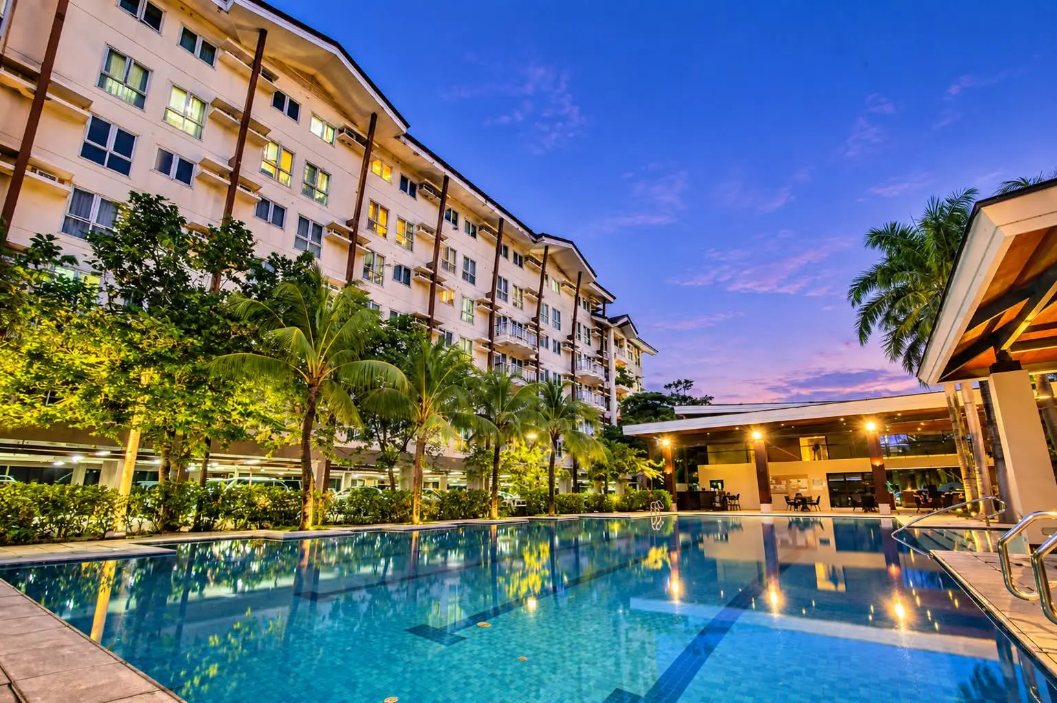 The condominium swimming pool and landscaped lounge area